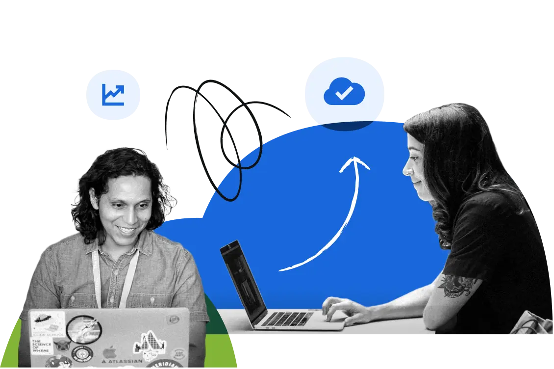Two Atlassians working on their laptops.